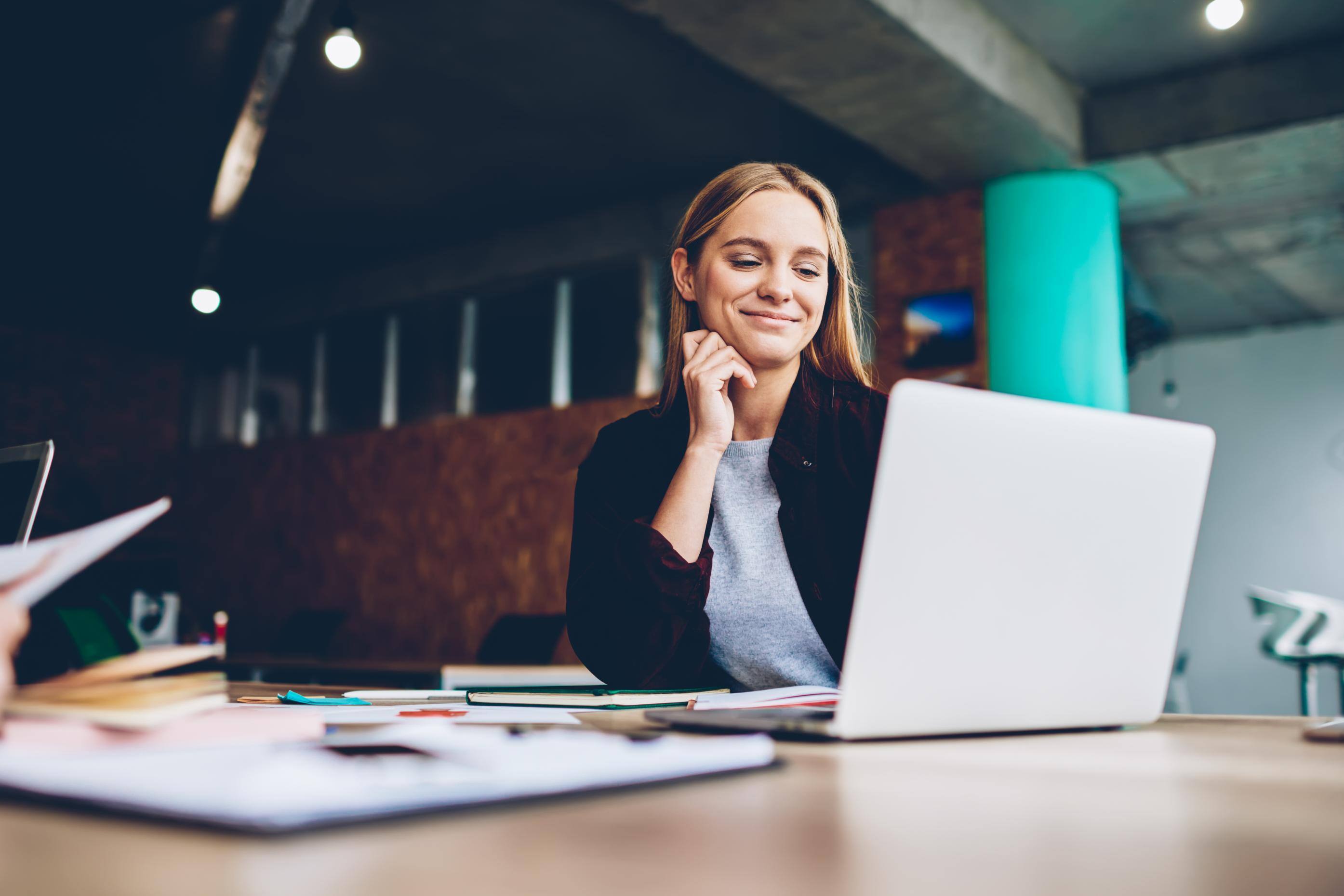 Business woman working on a laptop at a table