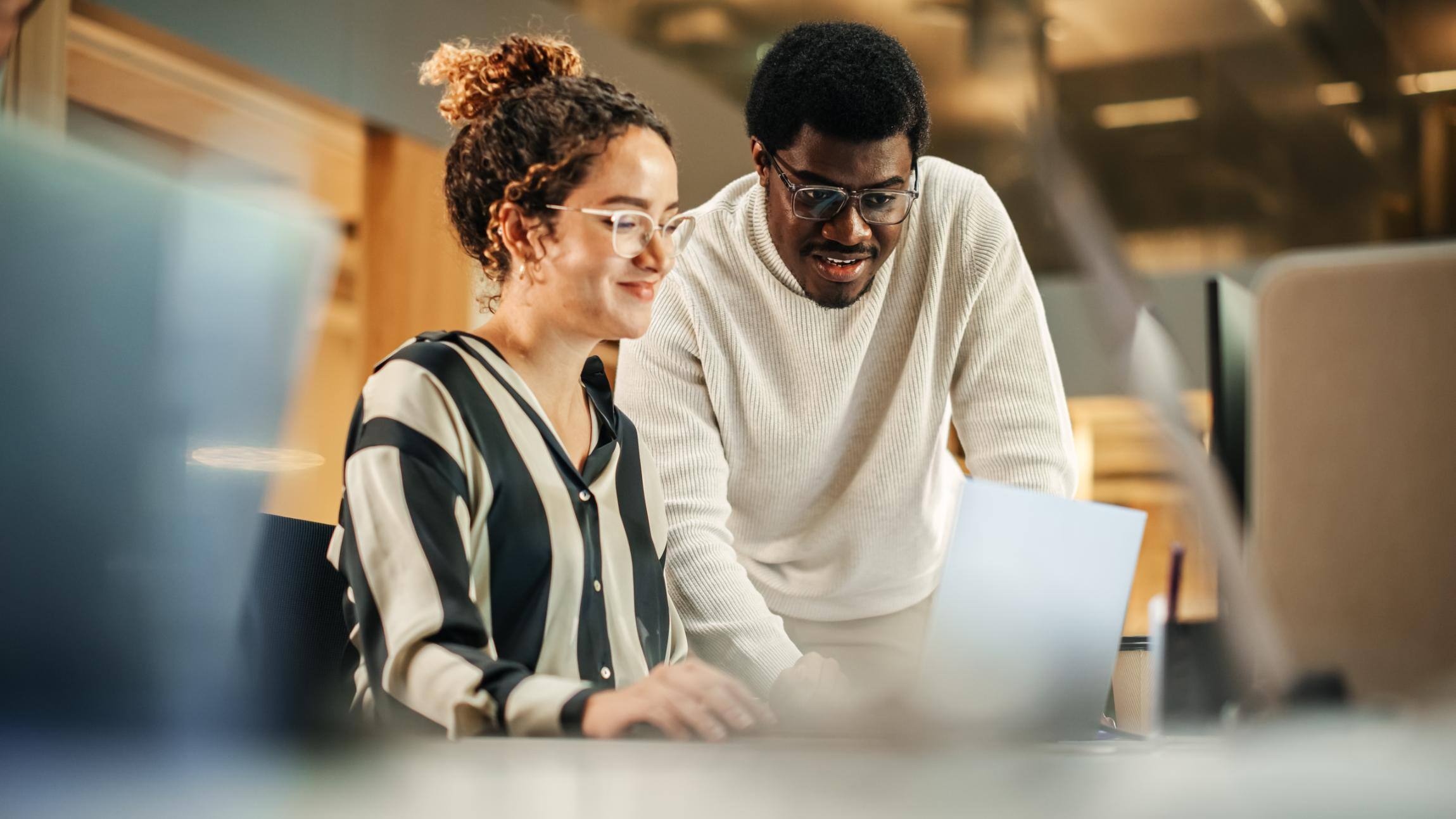 Business people looking at a laptop together at a table