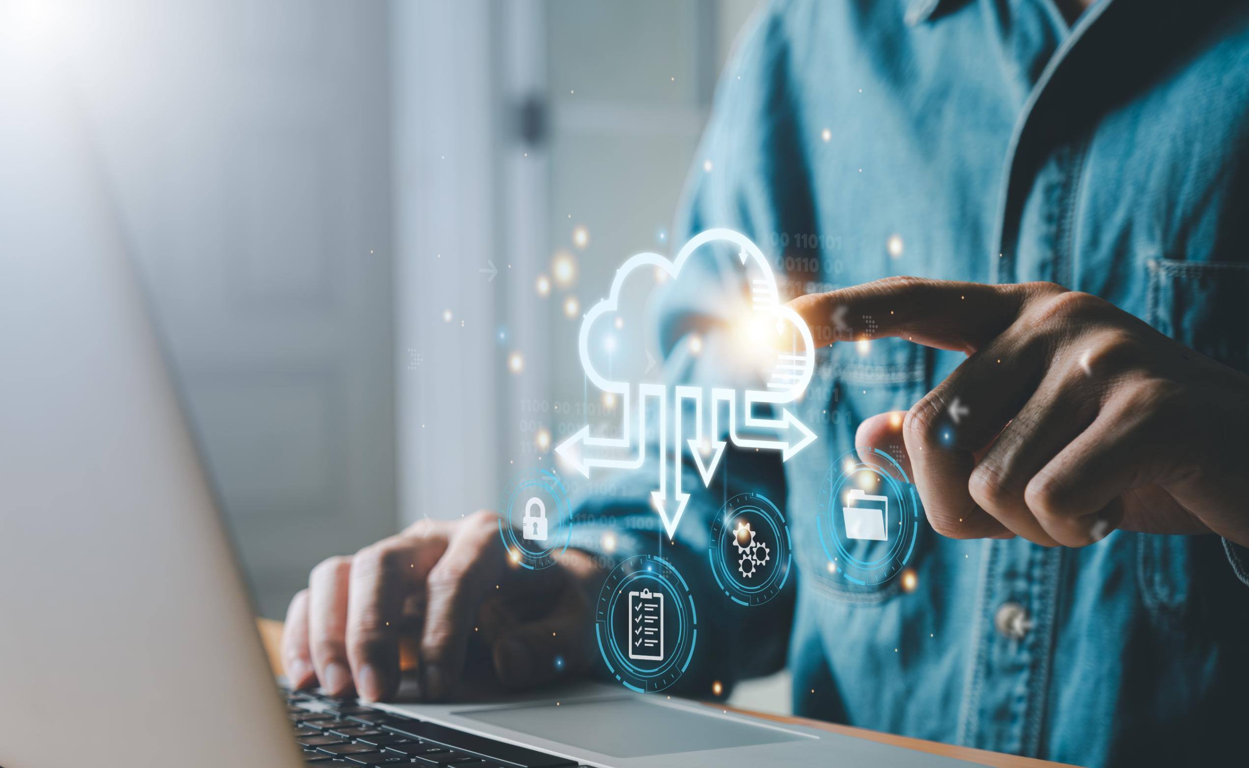 Business man working on computer with cloud icons