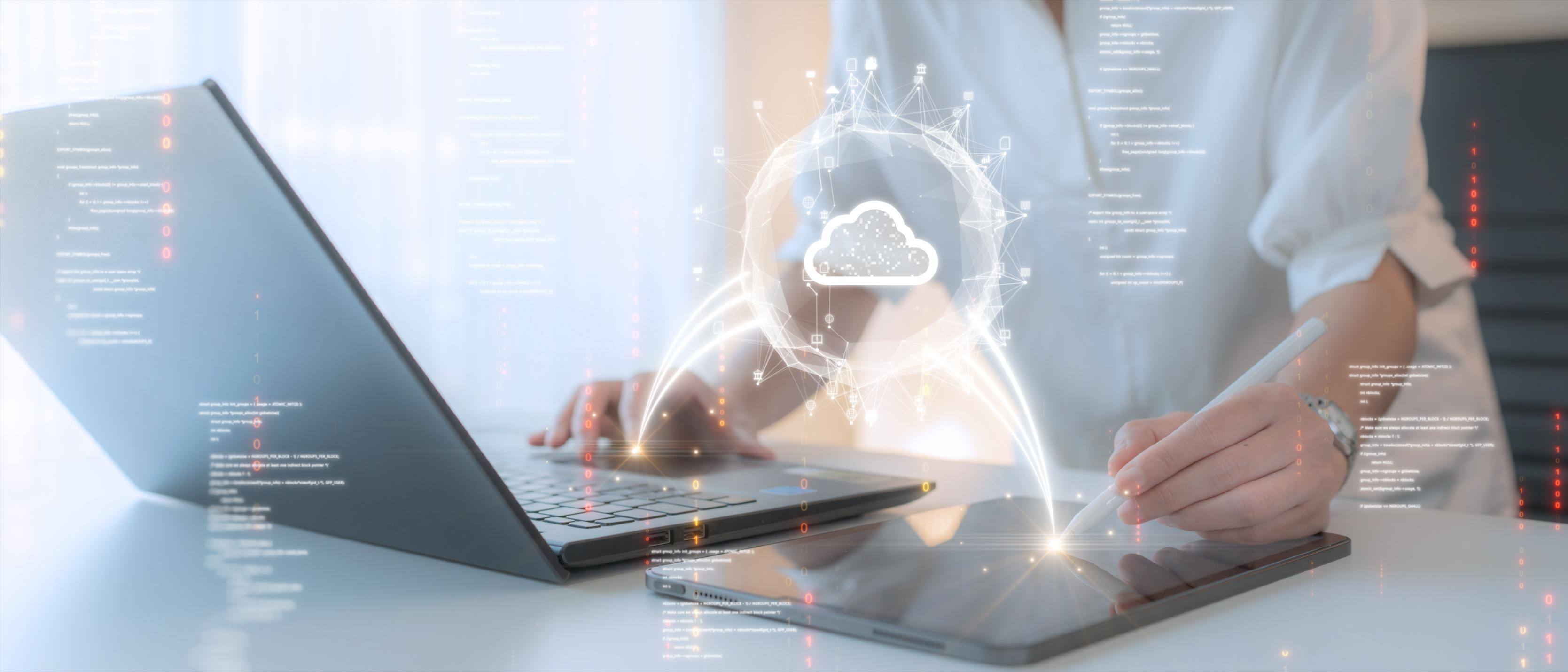 Person working on computer at a desk with a cloud icon over the image