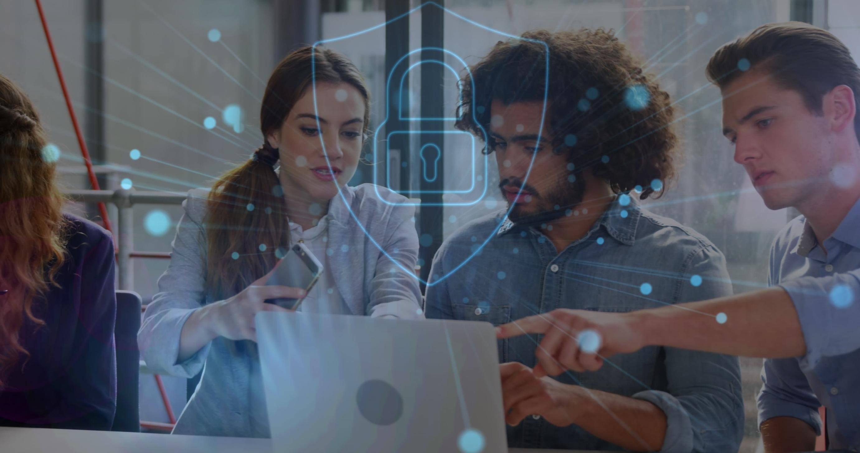 Business people working on a laptop with security graphics