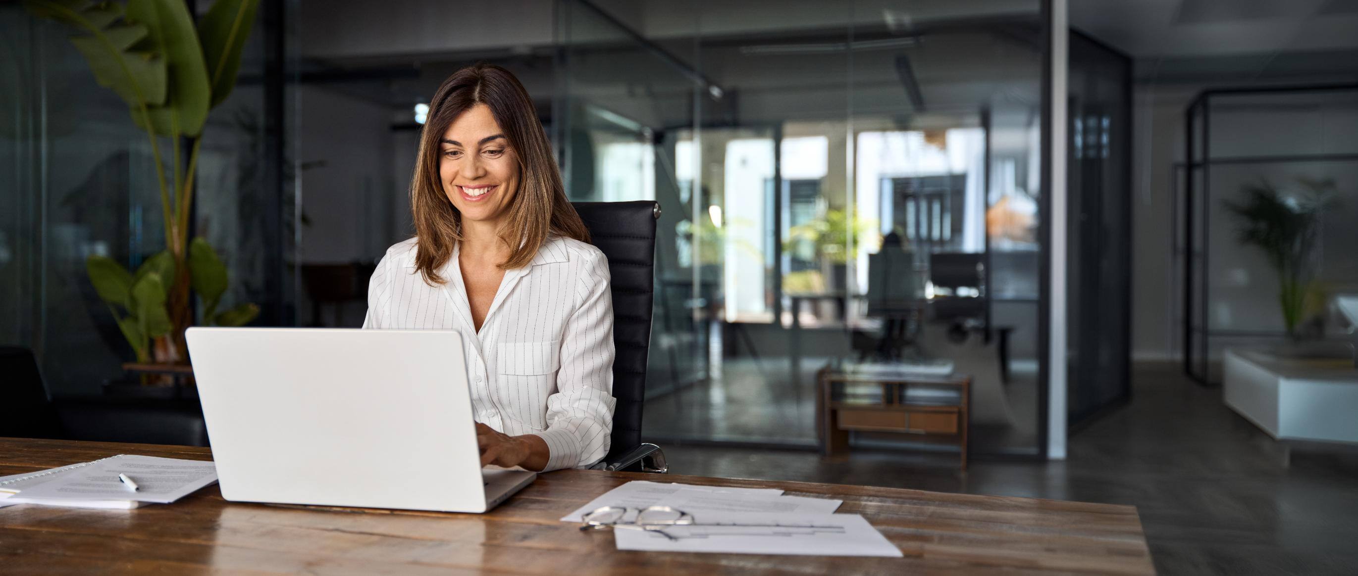 Business woman working on computer at a desk